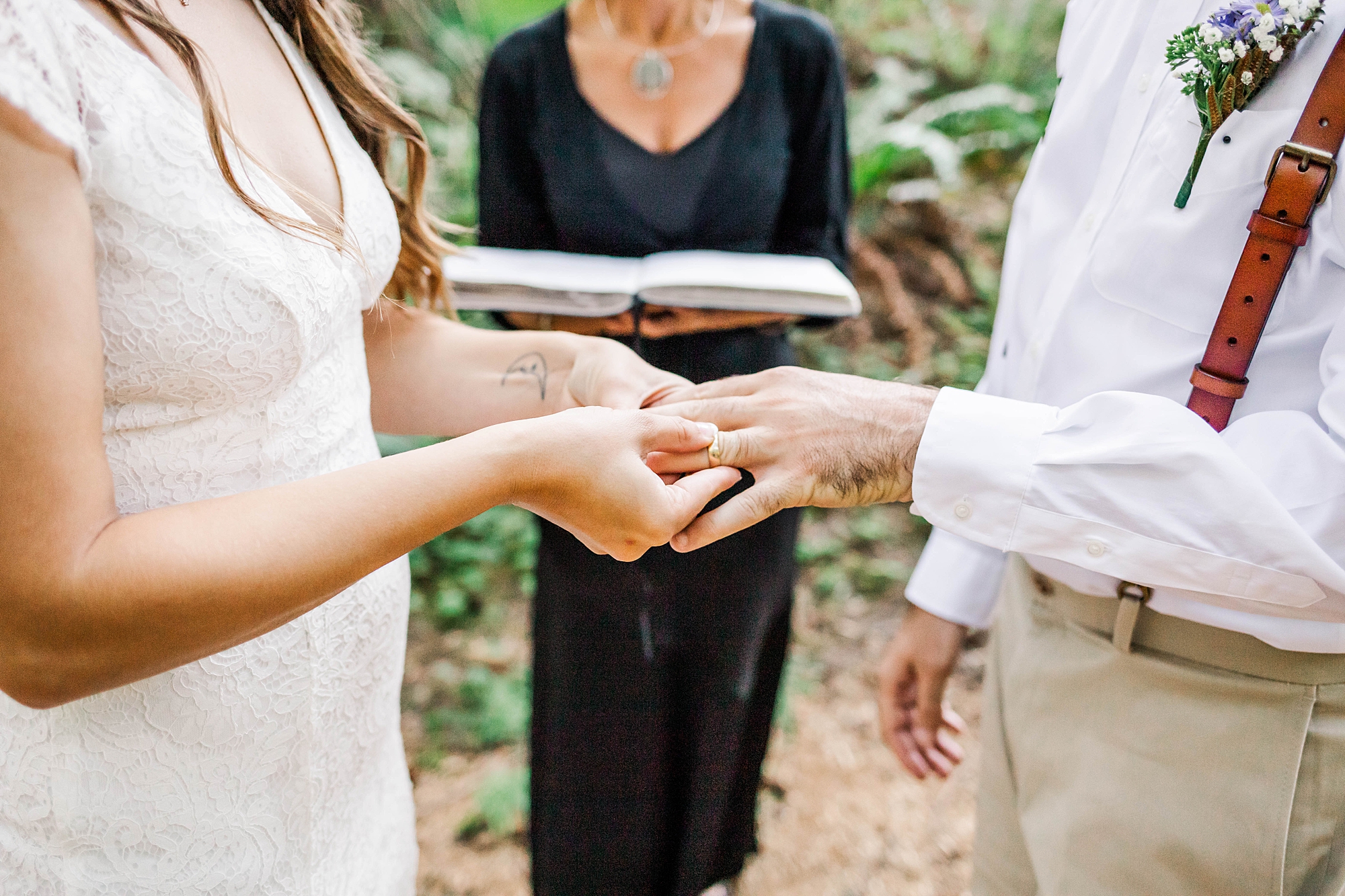 bride and groom exchange wedding rings